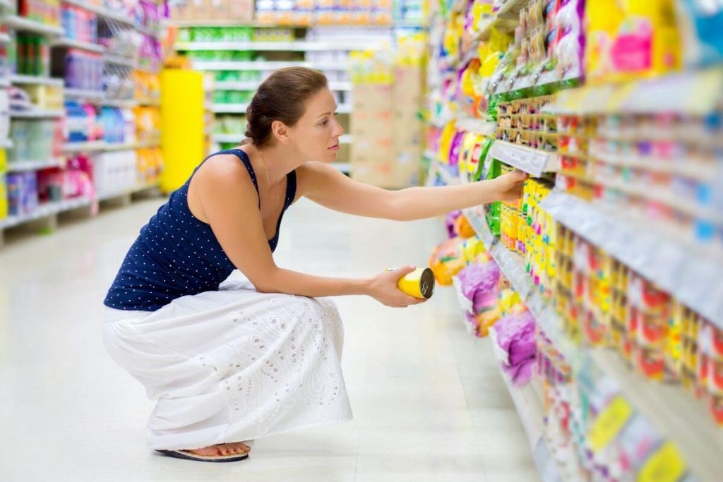 Woman reading labels in a supermarket