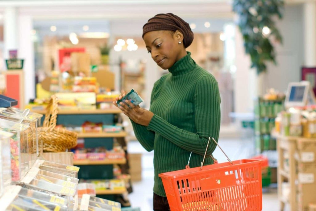Woman reading label of product in health foods store - Jupiterimages - Photo Images